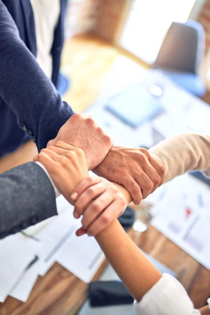 The Accessable Care team, hands joined together in unity