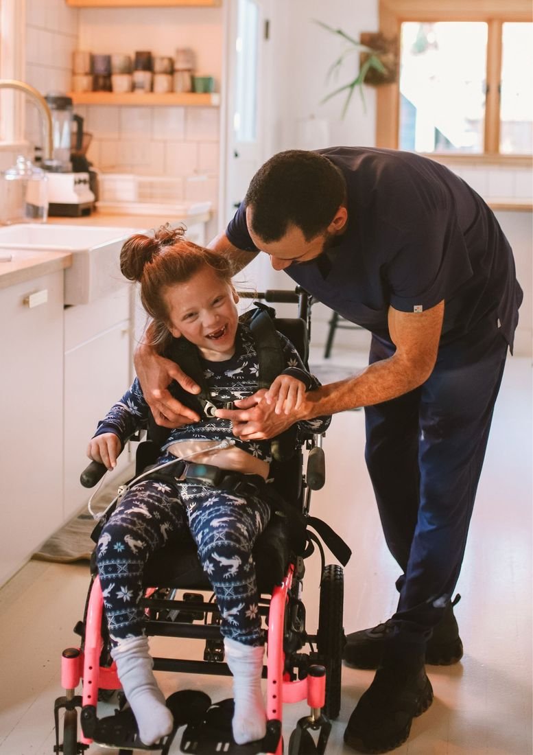 Accessable Care support worker with a young participant in her specialised wheelchair at home